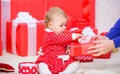 Sharing joy of baby first christmas with family. Baby first christmas once in lifetime event. Little baby play near pile