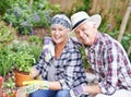 Sharing a love of gardening. A happy senior couple busy gardening in their back yard. Royalty Free Stock Photo