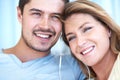 Sharing a love of music. Attractive young couple listening to music together on some earphones. Royalty Free Stock Photo