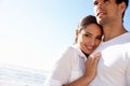 Sharing a loving gaze and a warm embrace. an affectionate young couple at the beach. Royalty Free Stock Photo