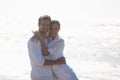 Sharing a loving gaze and a warm embrace. an affectionate young couple at the beach. Royalty Free Stock Photo