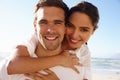 Sharing a loving gaze and a warm embrace. an affectionate young couple at the beach. Royalty Free Stock Photo