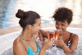 Sharing a luxurious experience with my best friend. two gorgeous young women enjoying a glass of champagne in a jacuzzi. Royalty Free Stock Photo