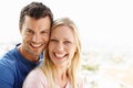 Sharing matching smiles of love and contentment. A happy young couple standing together and smiling. Royalty Free Stock Photo