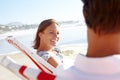 Sharing a relaxing day on the beach together. A happy couple sitting on deck-chairs on the beach and holding hands. Royalty Free Stock Photo