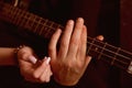 Sharing the rhythm of their life. Male and female hands play the electric guitar. Couple in love play duets. Couple of Royalty Free Stock Photo