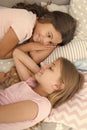 Sharing secrets. Kids relaxing on bed. Sisters preparing sleep. Nice evening. Best friends. Children friends. Charming