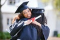 Sharing warm memories of the past and dreams of the future. Portrait of a young woman hugging her friend on graduation Royalty Free Stock Photo