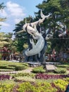 a shark battle with a crocodille statue in front of surabaya zoo