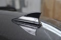 Shark fin car antenna. The radio antenna on the roof of the car Royalty Free Stock Photo