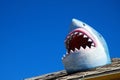 A shark humorously breaks through the roof at an arcade Royalty Free Stock Photo