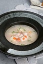 Shark soup in a black, deep plate