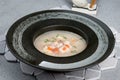 Shark soup in a black, deep plate