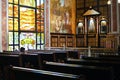 Sharm el Sheikh, Egypt - Detsember 26, 2019: Coptic Orthodox All Saints Church interior and windows decorations, wooden bench for