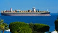 Sharm el-Sheikh, Egypt - March 14, 2018. A huge cargo ship carries containers with cargo in the Red Sea against the blue sky