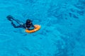 Sharm El Sheikh, Egypt, May 8, 2019: young man with a lifebuoy swims in sea blue water