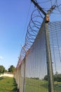 Sharp barbed wire on security fence protecti secure private space Royalty Free Stock Photo