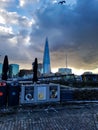 The sharp behind the snow on benches and tables at a cafe of London tower castle fortress winter day warm light at sky