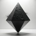 A sharp black geometric diamond shape polygon floats. Dust particles scatter around its textured surface. This abstract object is Royalty Free Stock Photo