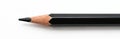Sharp black graphite pencil with wood casing. Single writing tool isolated on clean white background for art and office use. Royalty Free Stock Photo