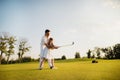 A sharp blow to the ball with a golf club. the girl made her first hit in golf Royalty Free Stock Photo