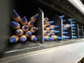 Sharp blue pencils stacked in a row, tips facing forward, in a dark storage container Royalty Free Stock Photo