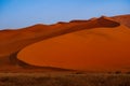 Sharp border of light and shadow over the crest of the dune. The Namib-Naukluft at sunset. Namibia, South Africa. The concept of e Royalty Free Stock Photo