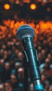 Sharp close up of microphone on stage with audience in clear focus, professional shot Royalty Free Stock Photo