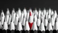 A sharp close up shot of a vibrant red colored pencil standing tall and prominently centered amongst a large crowd of uniformly Royalty Free Stock Photo
