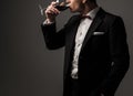 Sharp dressed man wearing jacket with glass of vine Royalty Free Stock Photo