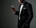 Sharp dressed man wearing jacket with glass of vine Royalty Free Stock Photo
