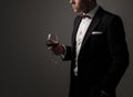 Sharp dressed man wearing jacket with glass of vine Royalty Free Stock Photo