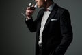 Sharp dressed man wearing jacket with glass of vine Royalty Free Stock Photo