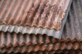 Sharp edges of the rusty metal sheets placed on the floor. Old aged weathered rusty galvanized corrugated iron sheet roof of Royalty Free Stock Photo