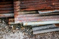 Sharp edges of the rusty metal sheets placed on the floor. Old aged weathered rusty galvanized corrugated iron sheet roof of Royalty Free Stock Photo