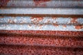 Sharp edges of the rusty metal sheets placed on the floor. Old aged weathered rusty galvanized corrugated iron sheet roof of Royalty Free Stock Photo