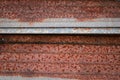 Sharp edges of the rusty metal sheets placed on the floor. Old aged weathered rusty galvanized corrugated iron sheet roof of