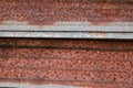 Sharp edges of the rusty metal sheets placed on the floor. Old aged weathered rusty galvanized corrugated iron sheet roof of