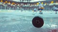 Sharp focus on ice hockey puck on ice rink with motion blur Royalty Free Stock Photo