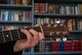 A Womans hand plays a C Chord on a classic Martin D28 guitar. Colorful image. Royalty Free Stock Photo