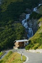 Sharp hairpin turn leads past a roadside hotel in the picturesque Dolomites.