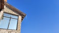 Sharp icicles from melted snow hanging from eaves of roof. Beautiful transparent icicles. Icicles on the eaves of the Royalty Free Stock Photo