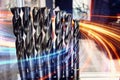 Sharp industrial drill bits with dynamic light trails overlay. Tools for drilling, construction, and manufacturing, representing Royalty Free Stock Photo