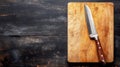 Sharp Kitchen Knife on Rustic Wooden Cutting Board, Culinary Background with Copy Space. Royalty Free Stock Photo
