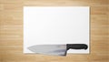 Sharp knife on white paper on wooden background stock photograph