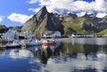 Sharp mountains and fishing boats reflected into the fjord in Hamnoy, Lofoten Islands