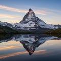 Sharp peak of the Matterhorn reflecting in a tranquil lake, surrounded by snow-clad Royalty Free Stock Photo