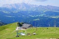 Sharp peaks rise above alpine summer meadows