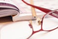 Sharp pencil in focus, eyeglass and crossword. Royalty Free Stock Photo