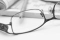Sharp pencil in focus, eyeglass and crossword. Royalty Free Stock Photo